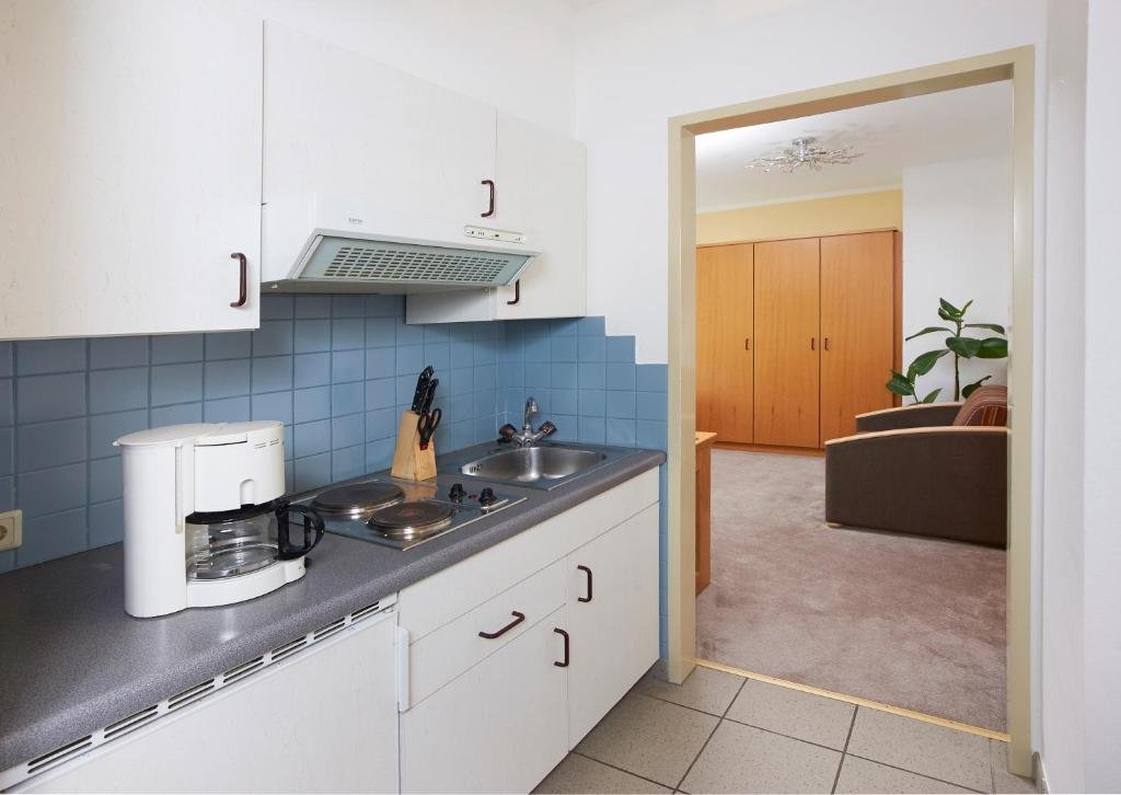 Küchenzeile im Doppelzimmer mit Kochfeld, Spüle und Stauraum